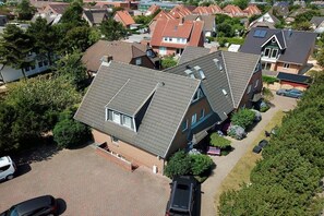 A residential area with houses featuring sloped roofs and a paved driveway. - Apartment in Westerland with swimming pool (Westerland)