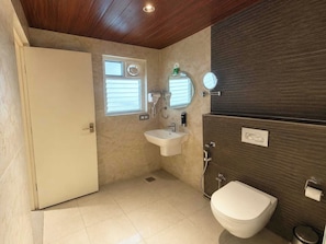 A bathroom with a toilet, sink, and mirror. - Hotel O Tirumala Hill View Tirupati (Tirupati)