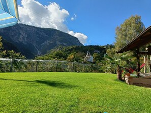 A grassy field with a mountain backdrop, a small building, and a clear sky. - Apartment 'Karin' with Wi-Fi (Appiano sulla strada del vino)