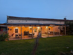A two-story building with a covered patio area.