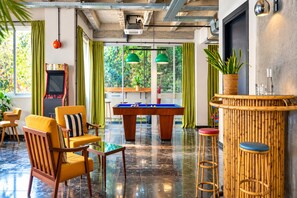 A billiards room with a pool table, chairs, and a bar area. - Max Brown Hotel Downtown, part of Sircle Collection - Standard Double Room (Athens)