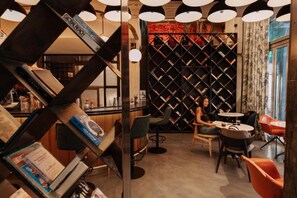 A bar area with bookshelves, a counter, and seating. - Max Brown Hotel Downtown, part of Sircle Collection - Standard Double Room (Athens)