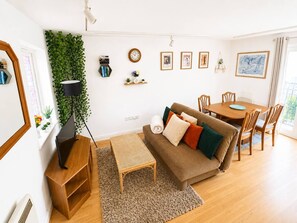 A modern living room with a sofa, coffee table, and dining table. - Central Bohemian Montpelier 1-Bed Flat | Sleeps 3 (Montpelier)