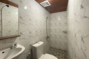 A bathroom with a sink, toilet, and shower. - Ava Hotel Bayeman Tidar (Magelang)