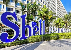 A large sign with the word 'Shell' and 'Residences' indicating a hotel or residential complex. - Shell Residences Cozy Staycation (Pasay)
