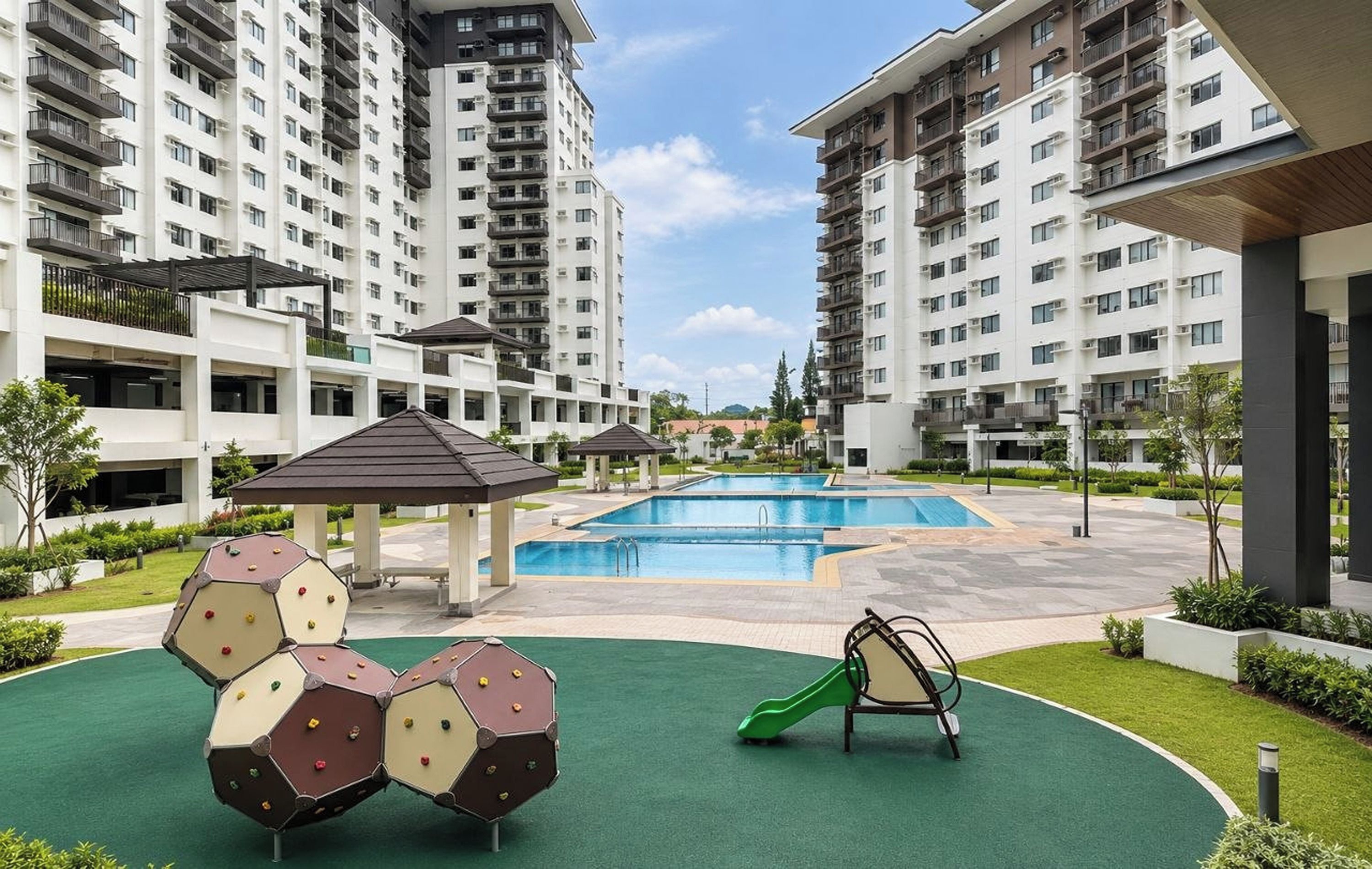 A residential building with multiple floors, a swimming pool, and outdoor play equipment.