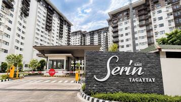 A gated entrance to a high-rise residential building with a sign reading 'Serin Tagaytay'.