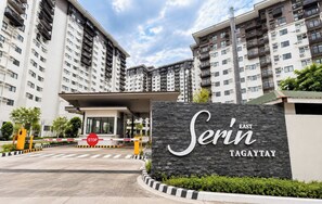 A gated entrance to a high-rise residential building with a sign reading 'Serin Tagaytay'. - Tagaytay Serin West Studio (Tagaytay)