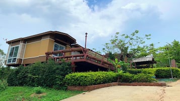 A modern two-story house with a covered porch and a brick pathway leading to the entrance.