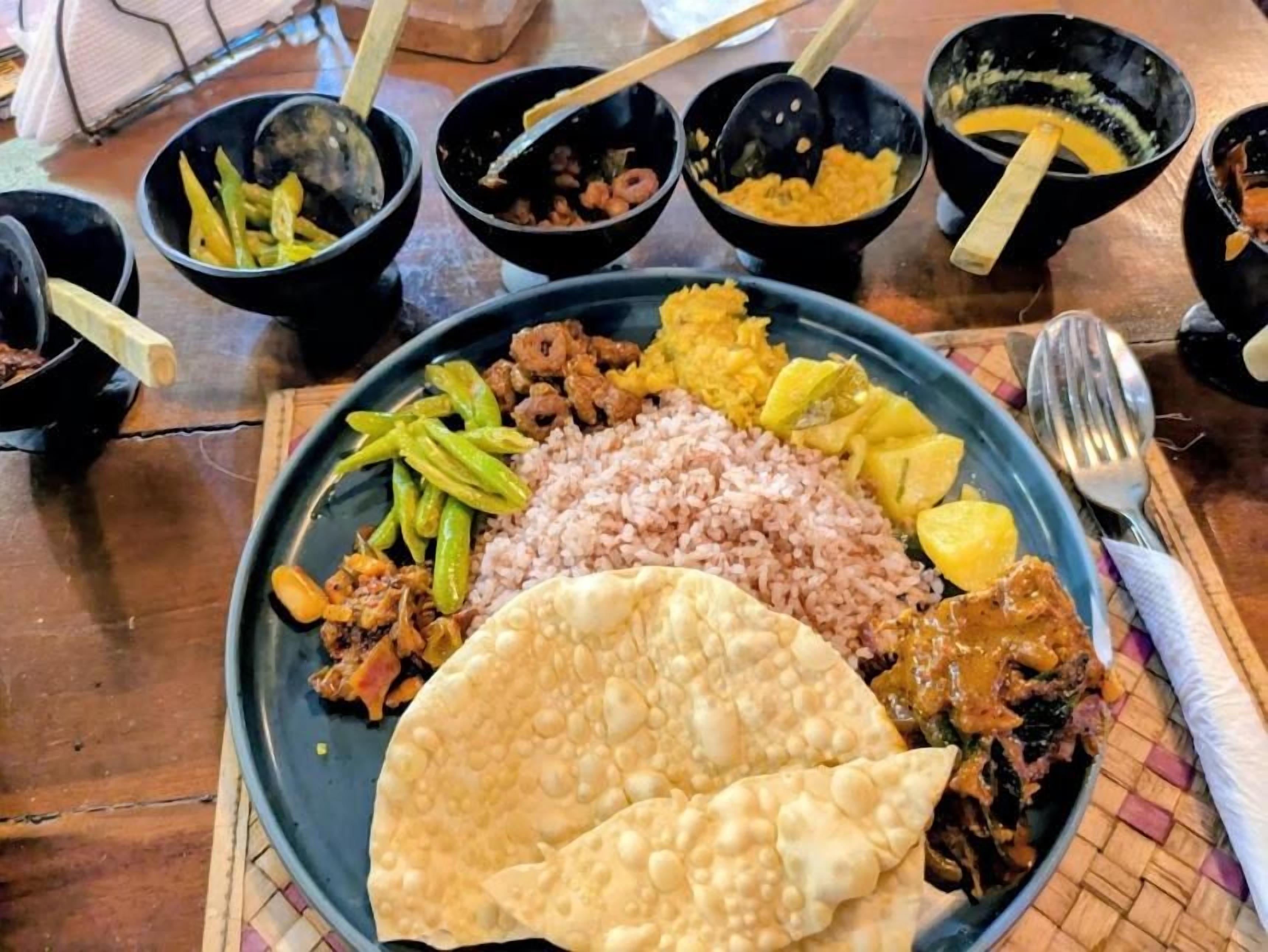 A plate of food with rice, green beans, and a tortilla.