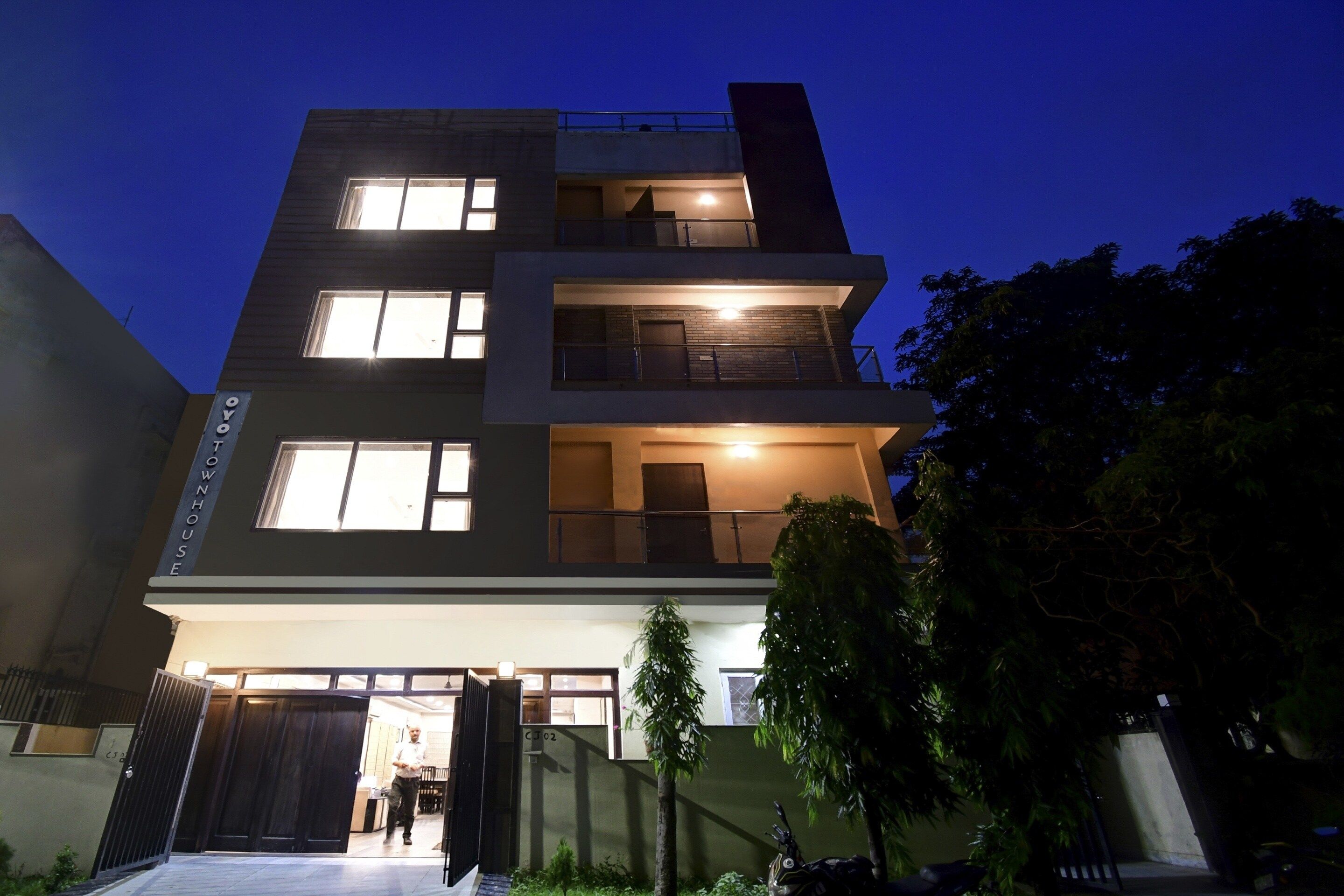 A multi-story residential building with a gated entrance, multiple windows, and a visible balcony.
