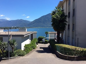 A residential street with a view of a lake and mountains in the distance. - Attico Luciana by Interhome (Minusio)