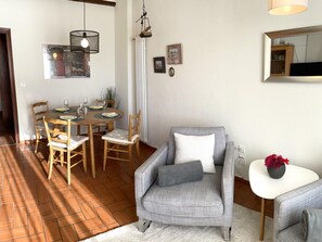 A dining area with a round table, chairs, and a hanging light fixture. - Casa Azalea by Interhome (Ronco sopra Ascona)