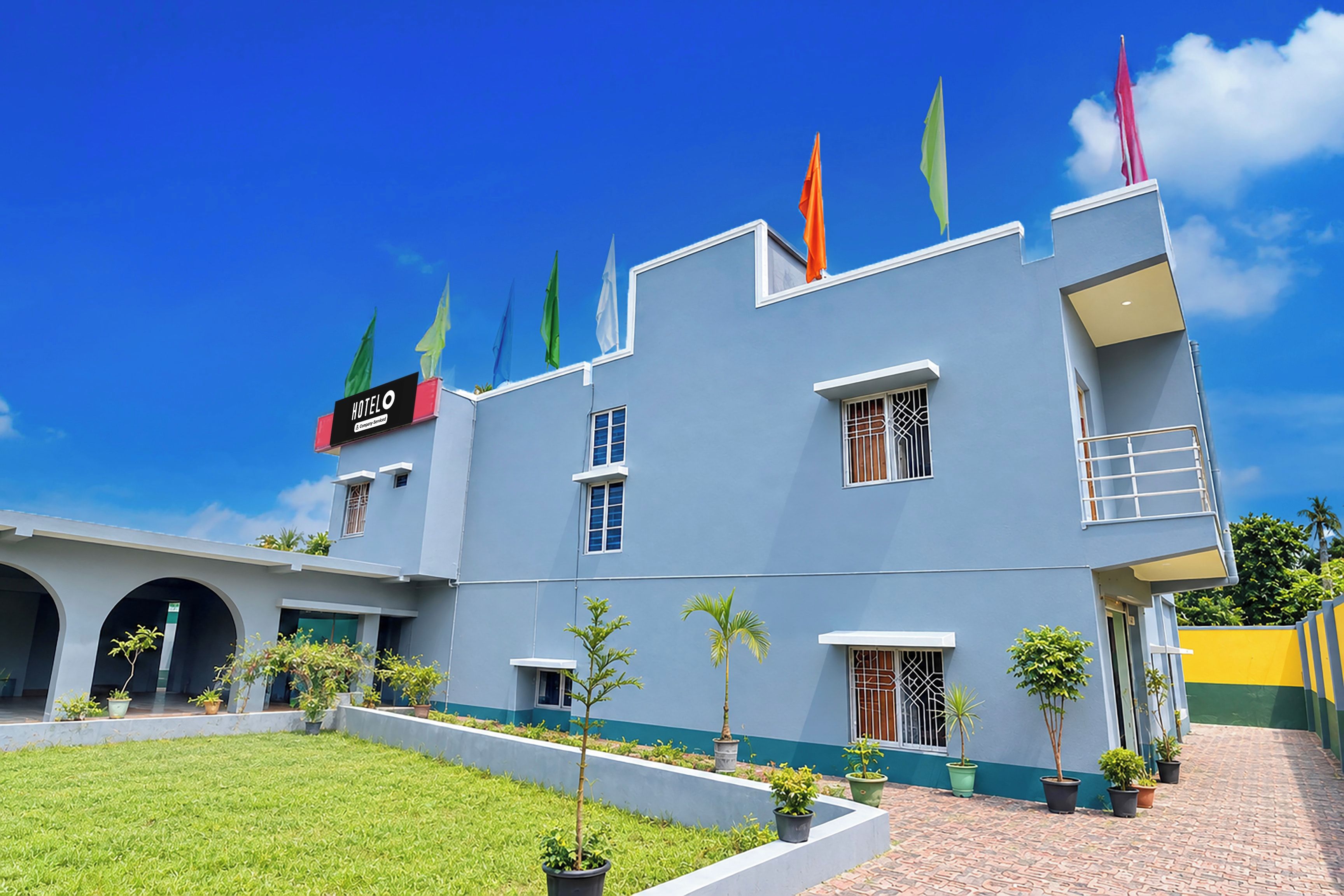 A hotel with a modern design, featuring a flat roof, multiple windows, and a sign indicating it is a hotel.