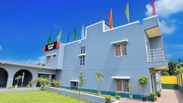 A hotel with a modern design, featuring a flat roof, multiple windows, and a sign indicating it is a hotel.