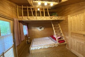 A wooden cabin interior with a bunk bed, a ladder, and a window with curtains. - Holiday home with 5 bedrooms (Riedlhütte)