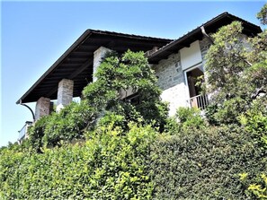 A house with a stone facade, a sloped roof, and a balcony. - Testa Nera by Interhome (Brione sopra Minusio)