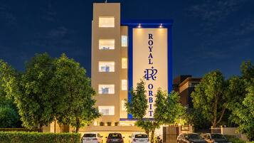 A hotel with a prominent vertical sign reading 'ROYAL ORBIT.'