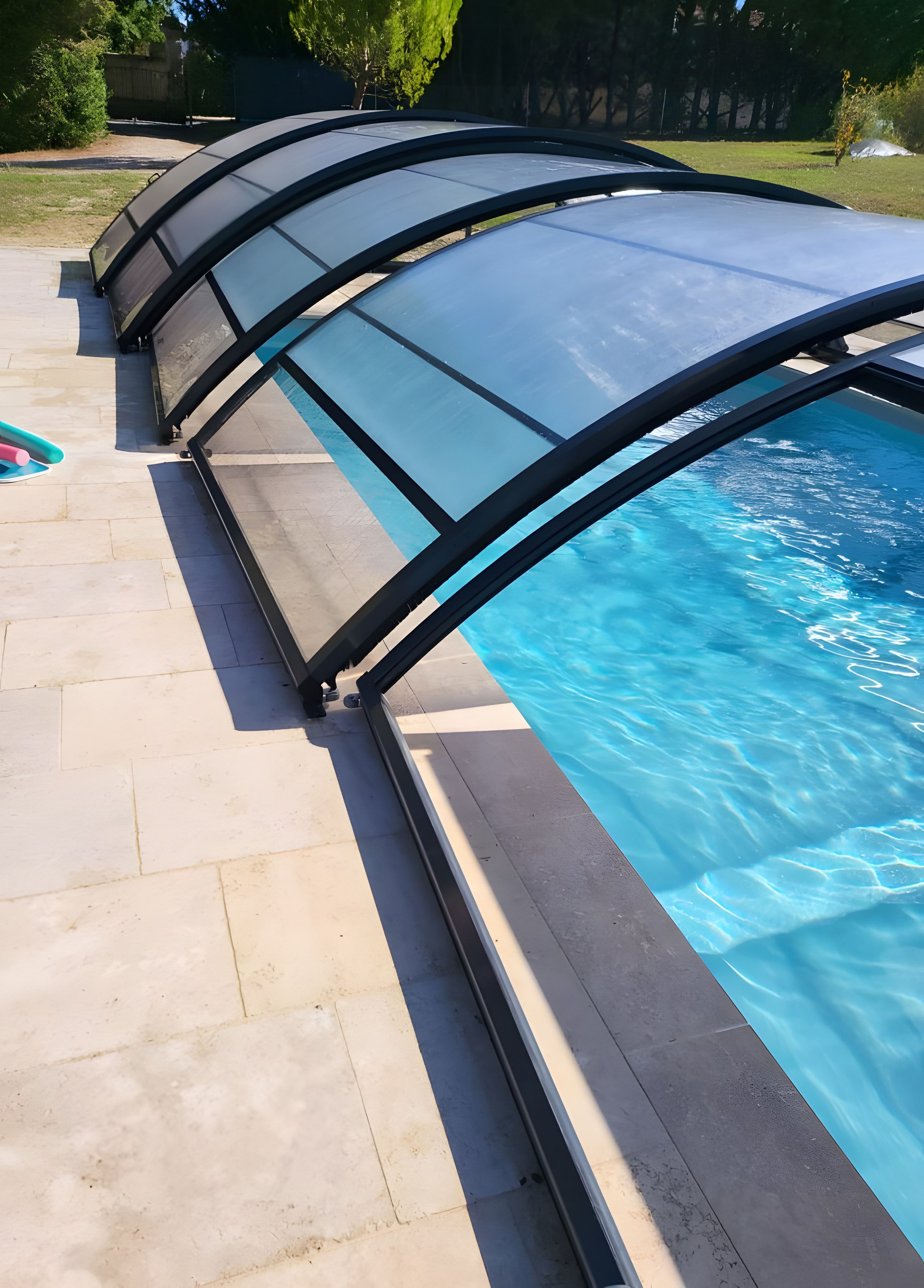 A swimming pool with a retractable cover.