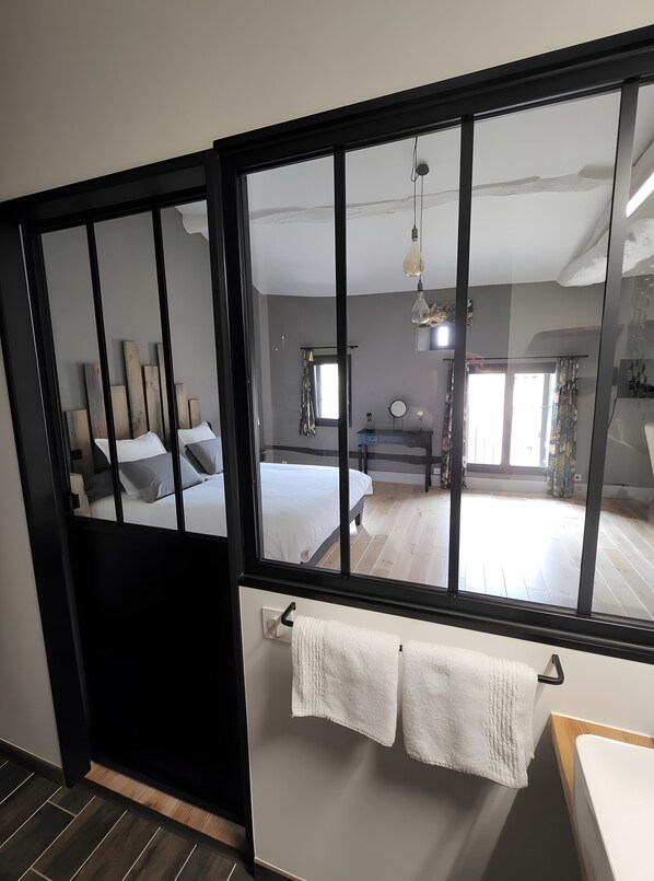 A room with a bed, a desk, and a window.