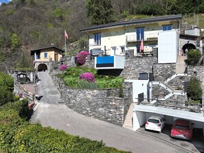 A hillside property with a stone staircase leading to a house with a balcony. - Casa Makatea by Interhome (Brione sopra Minusio)