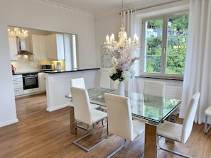 A modern kitchen with white cabinets, a microwave, and a stove. - Villa Grande Dame by Interhome (Minusio)