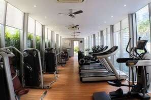 A gym with cardio machines, weight stations, and large windows offering views. - Skyline Service Suite KLCC at Vortex (Kuala Lumpur)