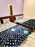 A double bed with a wooden headboard and a nightstand.