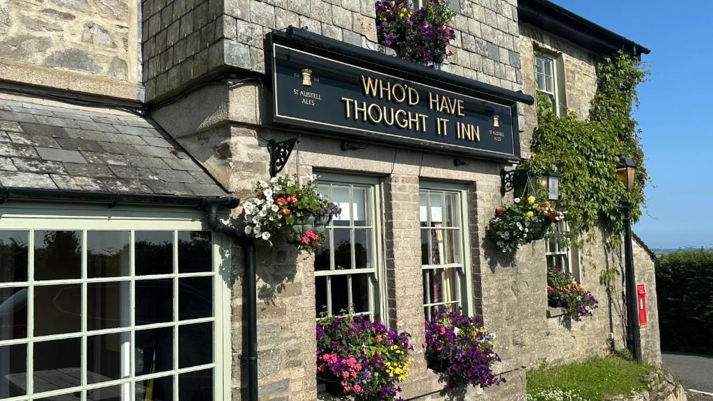 A stone building with a sign that reads 'WHOD HAVE THOUGHT IT INN' and 'S. AUSTELL ALES'.