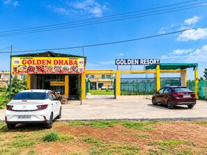 A restaurant named 'Golden DHABA' with a signboard listing various dishes. - Hotel O Gohana Junction Rohtak (Gohana)
