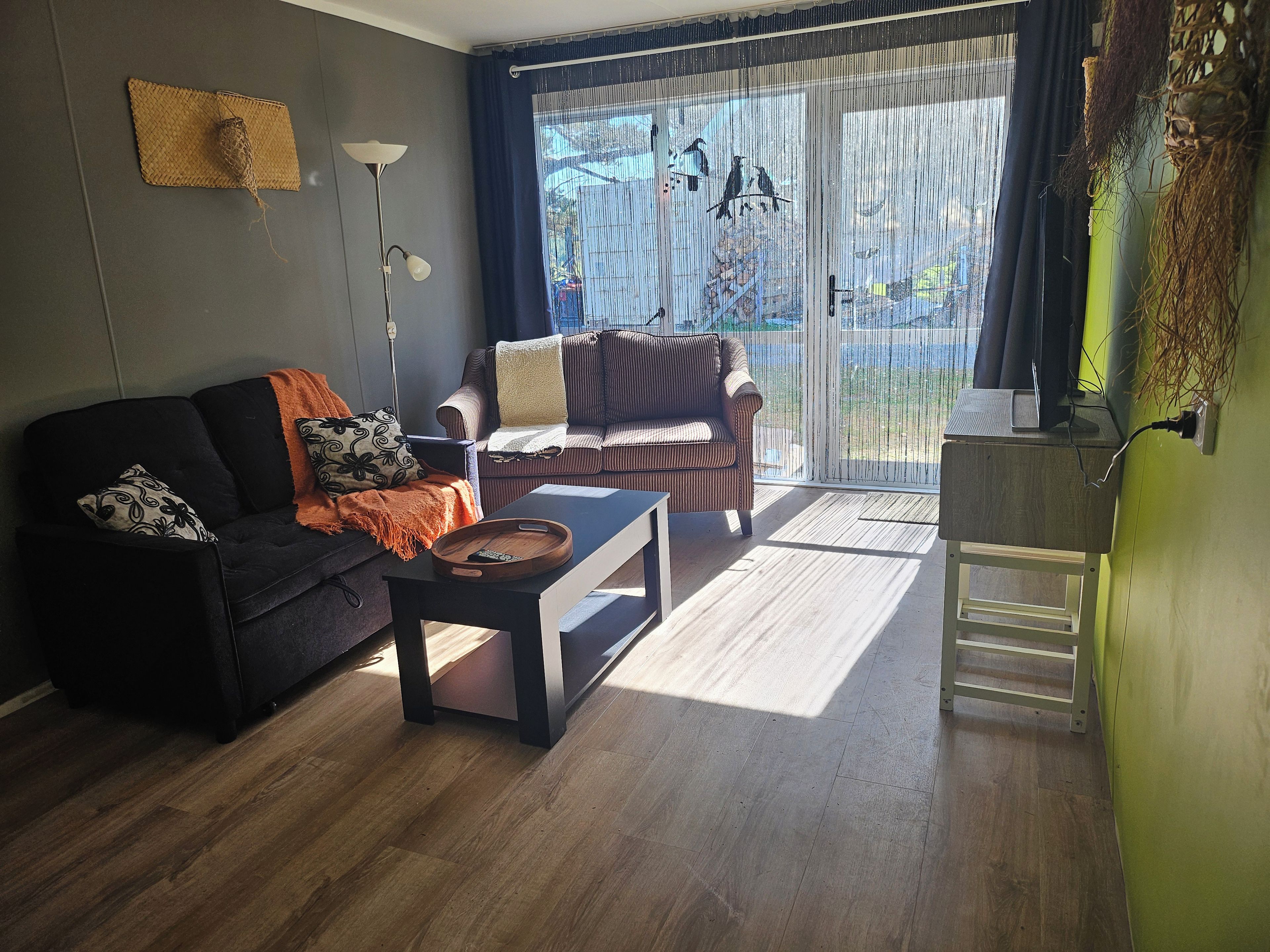 A living room with a sofa, a coffee table, and a lamp.