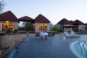 A resort with multiple buildings, outdoor seating, and a swimming pool. - Jawai Zinc Journey By The Fern, Jawai (Pali)