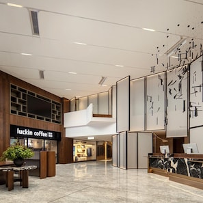 A modern interior with a coffee shop named 'Luckin Coffee' and a reception area with a marble counter. - Atour Hotel Shenzhen CBD Futian Metro Station (Shenzhen)