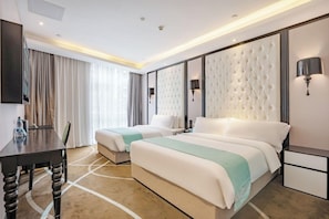 A hotel room with two beds, a desk, and a TV. - Pazhou Xana Deluxe International Hotel (Guangzhou)