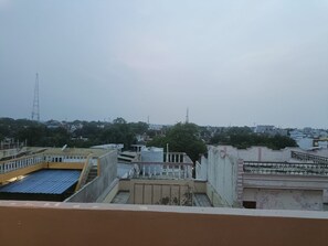 A view of a residential area with buildings, a water tank, and a tower in the distance. - SRG Hotel and Restruant (Dhauru Pur, Mirzapur)