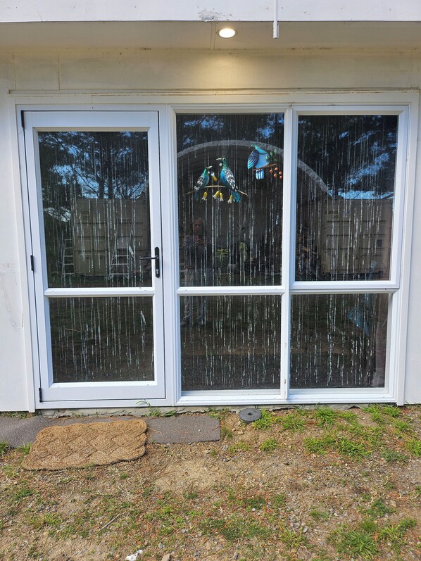 A set of white-framed windows with a clear view of the outside.