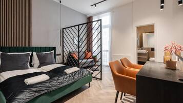A modern bedroom with a bed, a desk, and a chair.