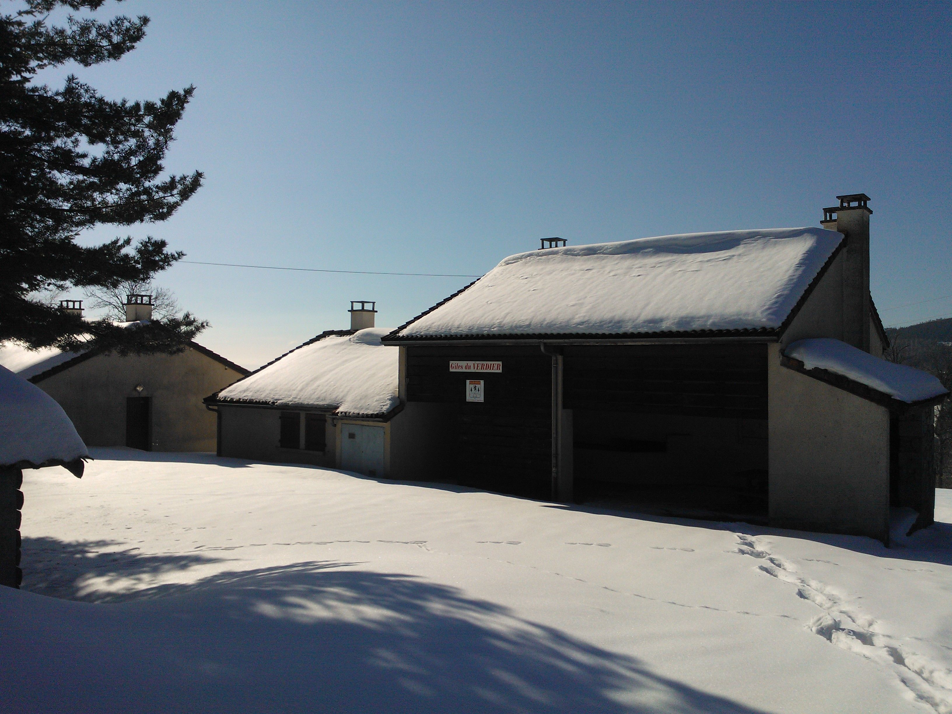 A snow-covered building with a sign indicating it is a hotel.