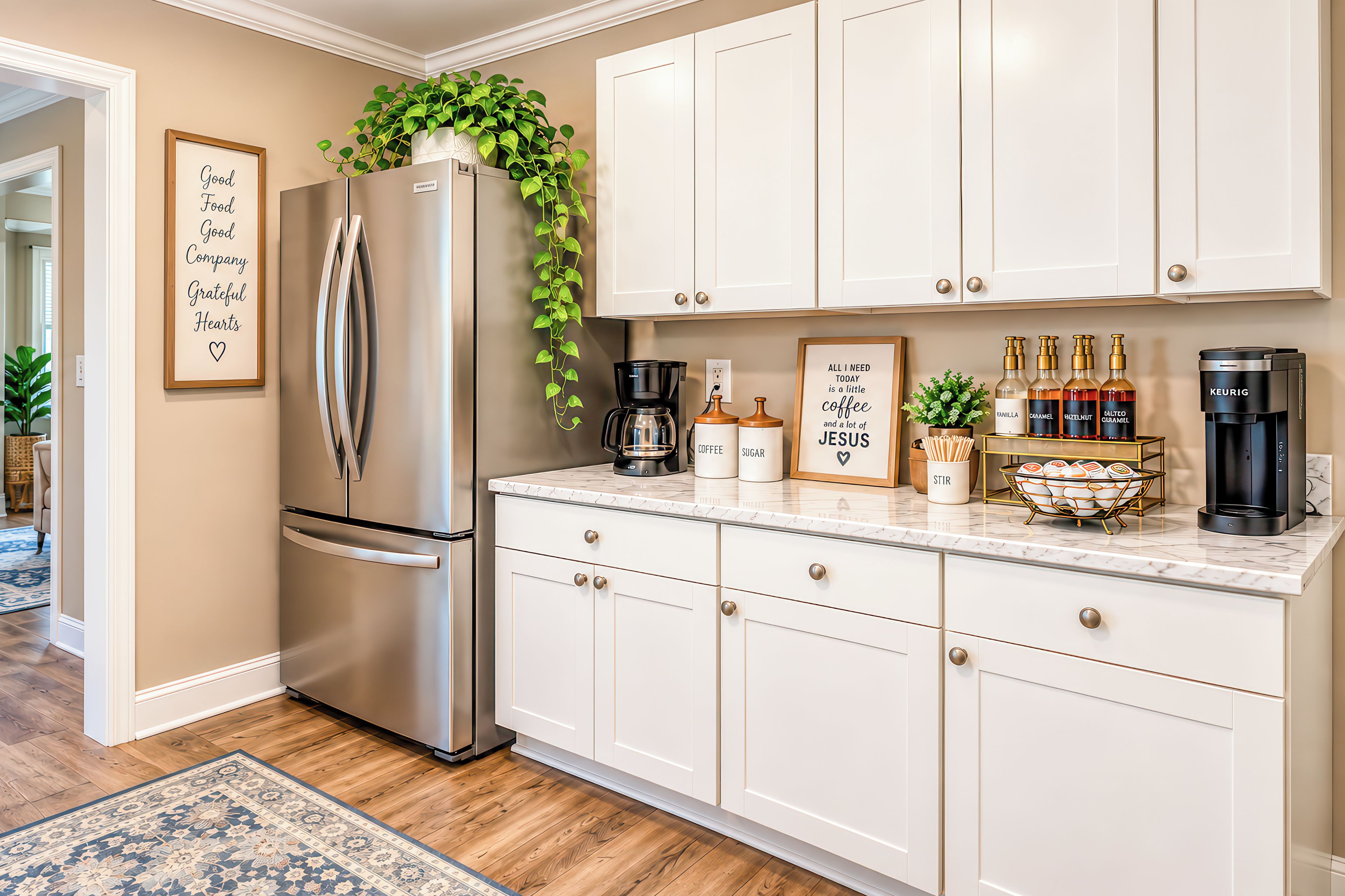A modern kitchen with white cabinetry, a stainless steel refrigerator, a coffee maker, and a Keurig coffee maker.