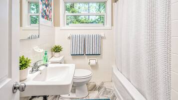 A bathroom with a sink, toilet, and bathtub.
