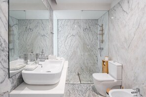 A modern bathroom with a large marble sink, a toilet, and a shower area. - Sunny Loft Historic Center Balcony (Porto)
