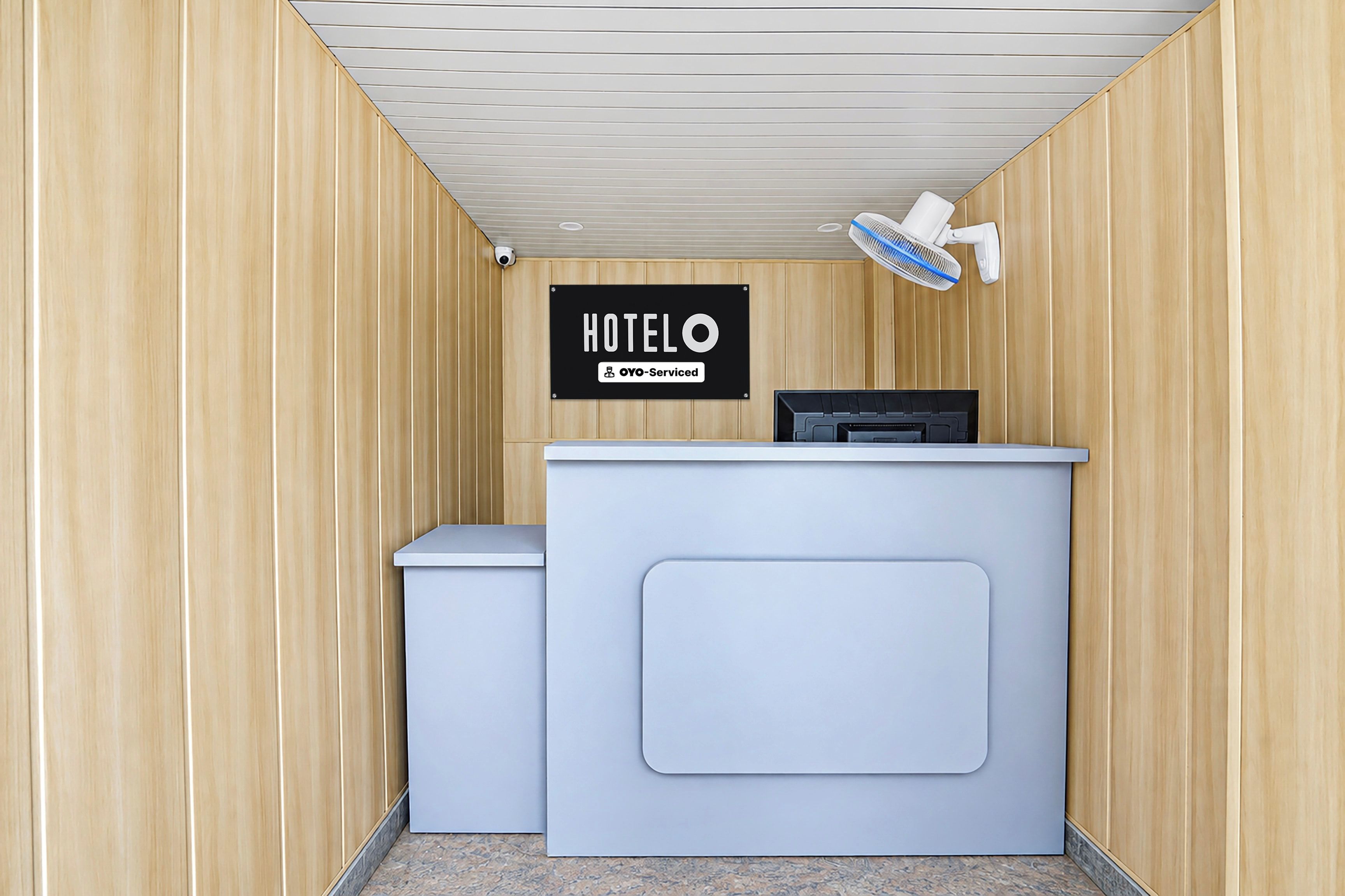 A hotel reception desk with a sign indicating it is OVO-serviced.