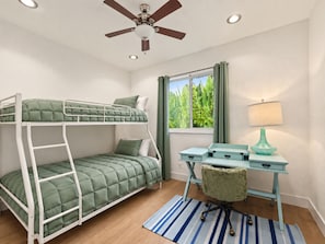 A bunk bed with a desk and chair, a ceiling fan, and a window with curtains. - Private Pool Home in Gated Palmetto Bay Community (Palmetto Bay)