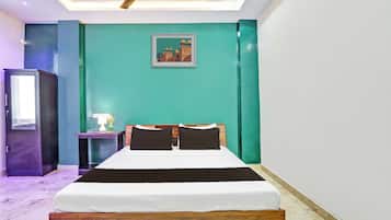 A bedroom with a bed, a nightstand, a lamp, and a ceiling fan.