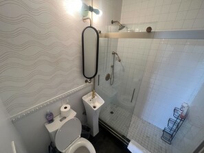 A bathroom with a toilet, sink, and shower. - Chic 420-Friendly LA Studio! Near Downtown! (Los Angeles)