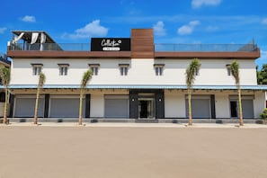A two-story building with a sign reading 'Collection OYO-Serviced' and a covered entrance. - Collection O Sector 10 Greater Noida (Noida)
