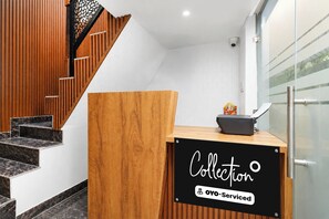 A reception desk with a sign reading 'Collection' and 'Oyo-Serviced'. - Collection O Sector 10 Greater Noida (Noida)