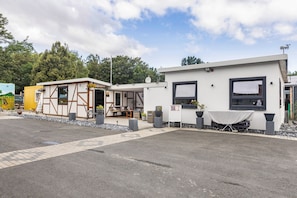 A row of small, single-story buildings with a simple, functional design, likely serving as temporary accommodations or service units. - Room 'Einzelzimmer 8' with Shared Garden and Wi-Fi (Stadtallendorf)