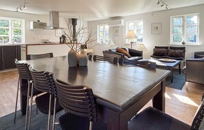 A spacious kitchen with a large dining table, modern appliances, and ample natural light. - 3 bedroom pet friendly home in Grenaa (Grenaa)