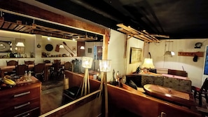 A cozy, rustic interior with wooden furniture, a dining area, and a bar space. - Villa Monera  (Mostar)
